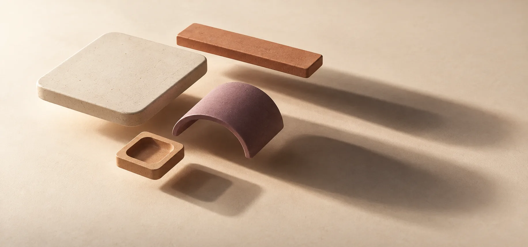 Ceramic forms casting layered soft shadows across a mineral surface.
